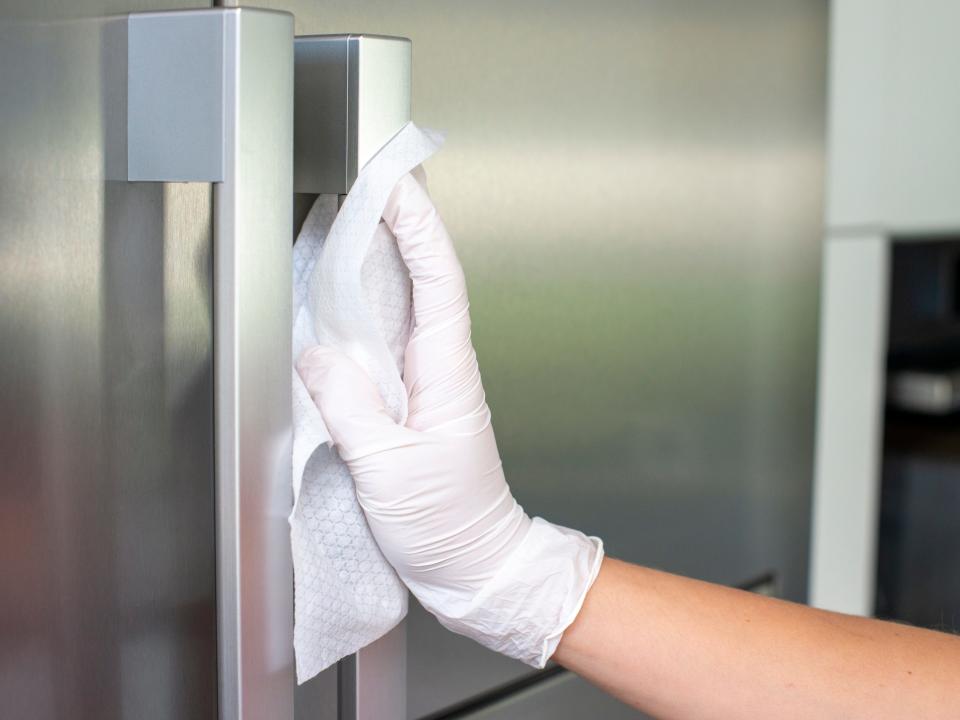 Person cleaning door handle