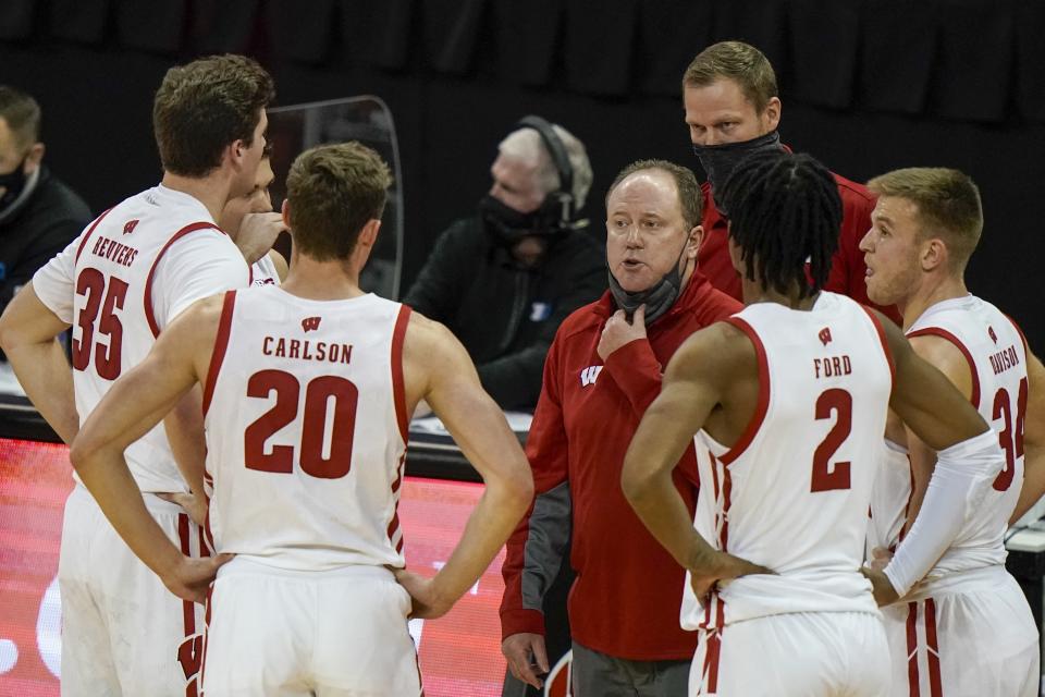 Wisconsin head coach Greg Gard talks to his players during the first half of an NCAA college basketball game against Wisconsin-Green Bay Tuesday, Dec. 1, 2020, in Madison, Wis. (AP Photo/Morry Gash)