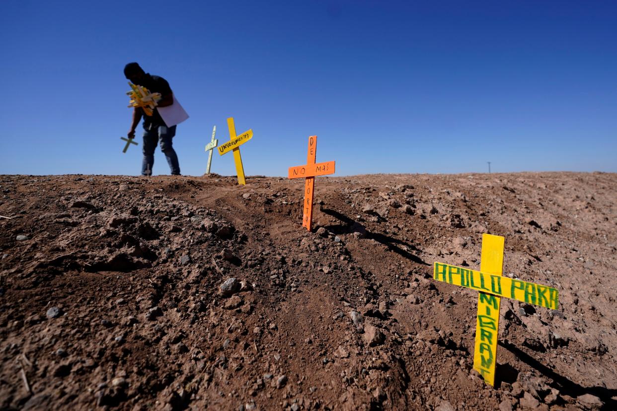 Hugo Castro leaves crosses at the scene of a deadly crash in Holtville, Calif. Tuesday, March 2, 2021.