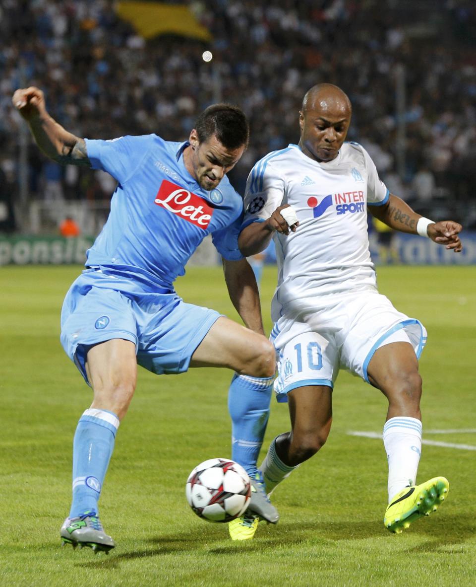 Olympique Marseille's Andre Ayew (R) challenges Napoli's Christian Maggio during their Champions League soccer match at the Velodrome stadium in Marseille, October 22, 2013. REUTERS/Philippe Laurenson (FRANCE - Tags: SPORT SOCCER)
