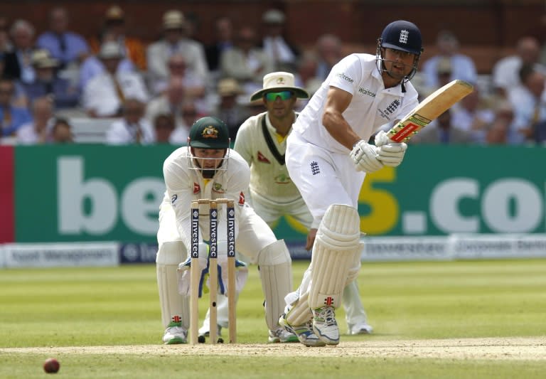 England captain Alastair Cook (R) plays a shot watched by Australia's wicketkeeper Peter Nevill on the third day of the second Ashes Test match at Lord's cricket ground on July 18, 2015