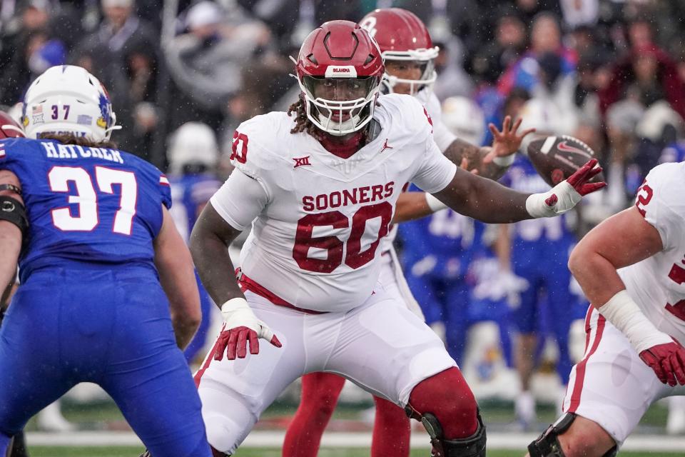 Oct 28, 2023; Lawrence, Kansas, USA; Oklahoma Sooners offensive lineman Tyler Guyton (60) at the line of scrimmage against the Kansas Jayhawks during the game at David Booth Kansas Memorial Stadium.