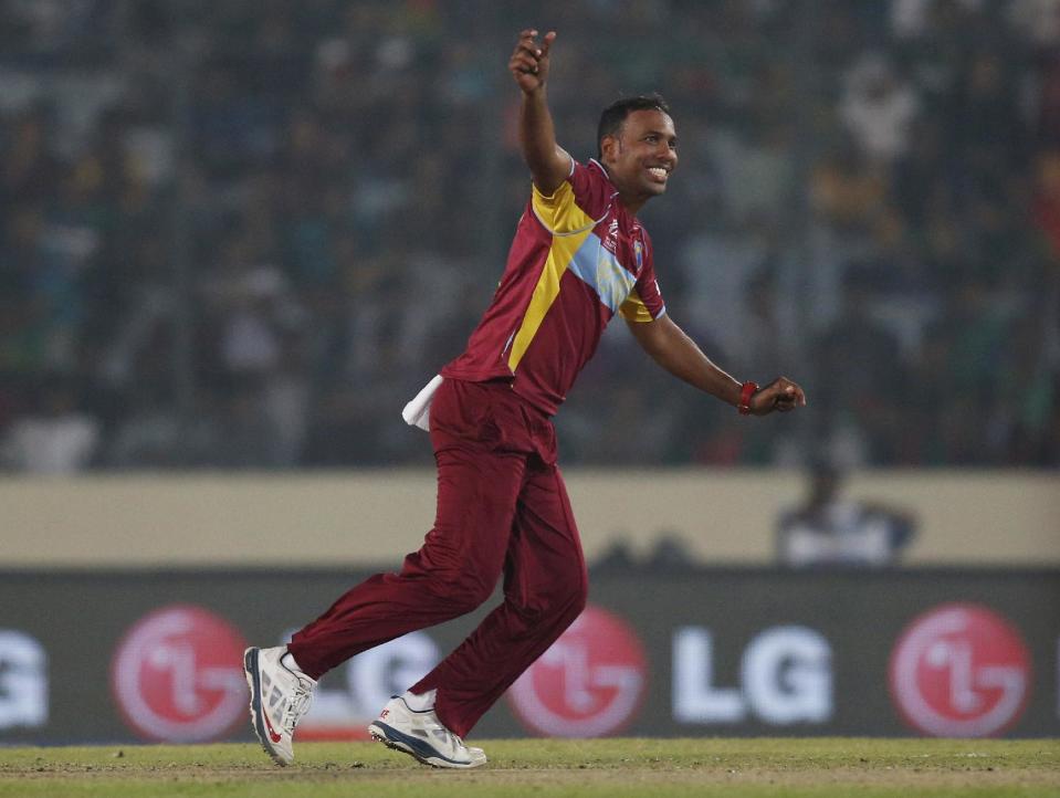 West Indies' bowler Samuel Badree celebrates the dismissal of Bangladesh batsman Mahmudullah during their ICC Twenty20 Cricket World Cup match in Dhaka, Bangladesh, Tuesday, March 25, 2014. (AP Photo/Aijaz Rahi)