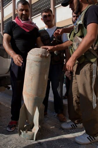 Free Syrian Army members precariously handle an unexploded bomb that was dropped by a Syrian Army MIG fighter jet onto a hospital in the Sahoul area of Aleppo, near the headquarters of the opposition on August 7. Syria said its troops seized a rebel-held Aleppo district on Wednesday after storming it and "annihilating" most of the insurgents