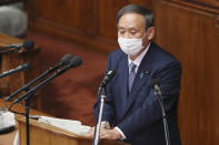 Japanese Prime Minister Yoshihide Suga delivers a policy speech during an extraordinary Diet session at the upper house of parliament in Tokyo, Monday, Oct. 26, 2020. Suga has declared Japan will achieve zero carbon emissions by 2050 in his first policy speech after taking over from Shinzo Abe. The policy speech Monday at the outset of the parliamentary session set an ambitious agenda reflecting Suga's pragmatic approach to getting things done. (AP Photo/Koji Sasahara)