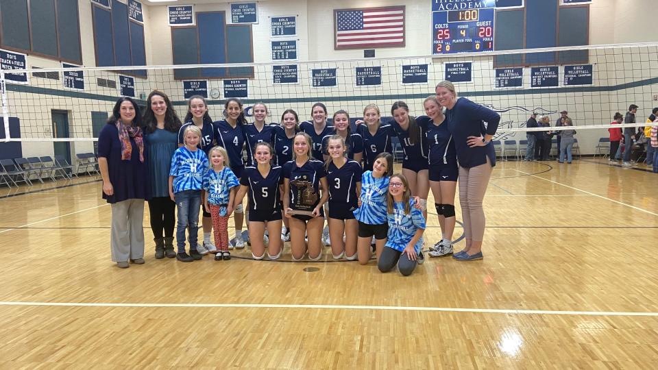 Division 4 District 118 Champions: The 2021 Hillsdale Academy Colts Volleyball Team. Pictured with head coach Katherine Huffman (Right) and assistants Heather Miller and Jenny Welden (Left). (Front Row) Junior Megan Roberts (#5), Senior Emma Waldvogel (#12), and Senior Anna Roberts (#3). (Back Row Left to Right): (#15) Sophomore Evie Gray, (#4) Sophomore Haven Socha, (#7) Sophomore Jalyn Fischer, (#2) Sophomore Nora Teloar, (#17) Keturah Neukom, (#14) Junior Ava Postula, (#6) Junior Faith Miller, (#10) Sophomore Ava King, and (#1) Freshman Clara Heath.