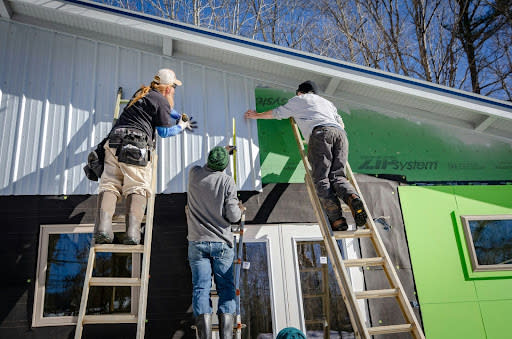 Home on ladders doing home improvements (Credit: Jens Behrmann via Unsplash)