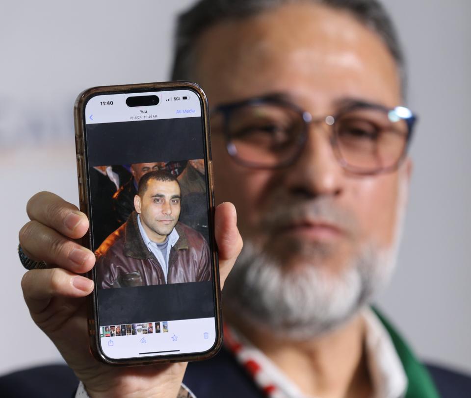 Newark, NJ -- February 15, 2024 -- Adam Abosheriah holds a photo of his cousin who lives in Gaza and has been abducted. He and others who are concerned for relatives in Gaza took part in a press conference held by CAIR at their office in Newark.