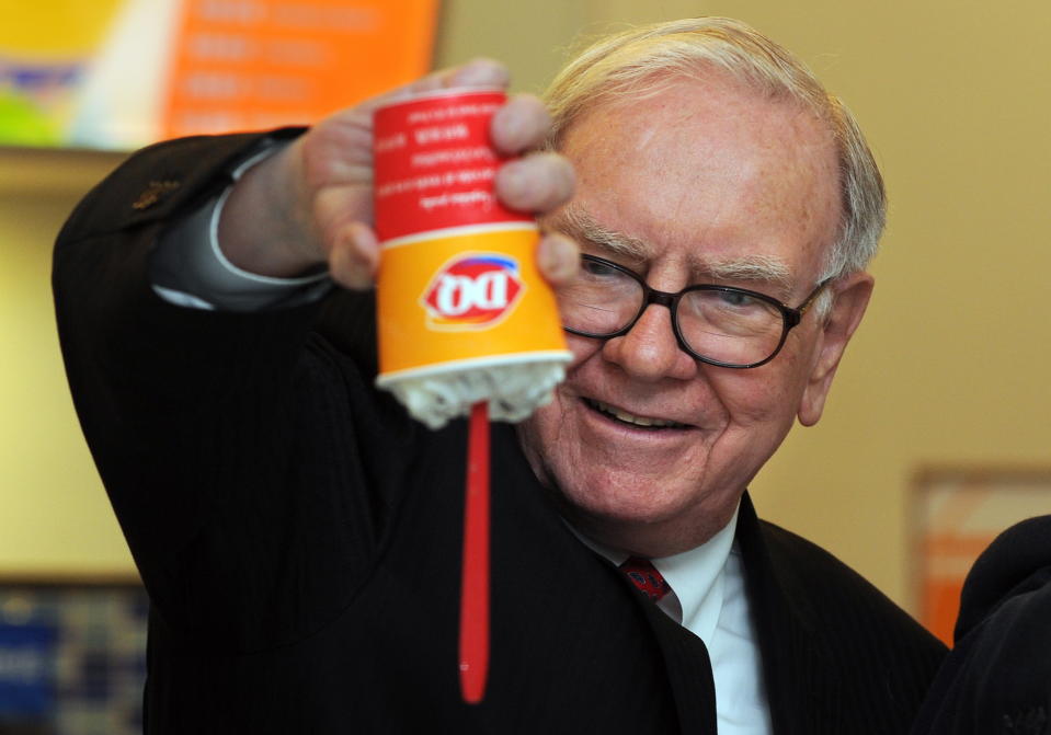 US billionaire investor Warren Buffett flips over a Dairy Queen Blizzard treat, the most successful product ever released in the history of Dairy Queen, a US desert chain with over 300 stores in China, at the opening of a new branch in Beijing on September 30, 2010.  Bill Gates and Buffett hosted a banquet the previous night for China's super rich that sparked debate about Chinese philanthropy, amid reports that wealthy invitees had been reluctant to attend. The two, who have already persuaded 40 wealthy US individuals to hand over more than half of their fortunes, had insisted they would not pressure attendees for money and simply wanted to learn about charity in China. Buffett is the CEO of Berkshire Hathaway which owns Dairy Queen. AFP PHOTO/Frederic J. BROWN (Photo credit should read FREDERIC J. BROWN/AFP via Getty Images)