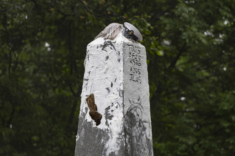 The Navy Sailor hat "Dixie Cup" and an upperclassmen's cap sit together atop the 21 foot Herndon Monument during a failed attempt by "Plebes" to remove the cup, during the annual Herndon Monument Climb at the U.S. Naval Academy, Wednesday, May 15, 2024, in Annapolis, Md. Freshmen, known as Plebes, participate in the climb to celebrate finishing their first year at the academy. The climb was completed in two hours, nineteen minsters and eleven seconds to complete. (AP Photo/Tom Brenner)