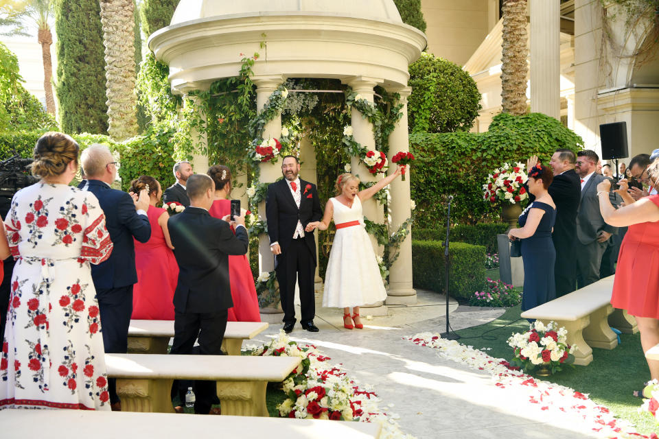 LAS VEGAS, NEVADA - OCTOBER 02: (EXCLUSIVE COVERAGE)  Sharon Cook (R) and Andrew Aitchison (L) from Liverpool, England react to Sir Rod Stewart singing at their wedding. The wedding was nearly cancelled due to the Thomas Cook Bankruptcy. Caesars Palace and Delta Air Lines flew the couple and their guests to Las Vegas as originally planned. The Wedding took place at Caesars Palace on October 02, 2019 in Las Vegas, Nevada. (Photo by Denise Truscello/WireImage)