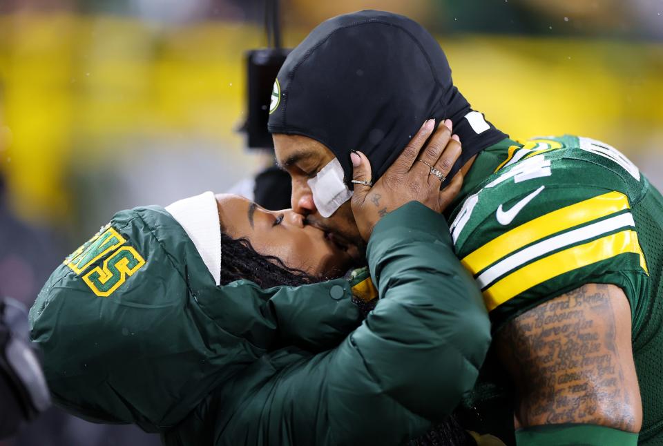 Olympic gold medalist Simone Biles kisses husband Jonathan Owens of the Green Bay Packers before the game against the Kansas City Chiefs on Dec. 3, 2023, at Lambeau Field.