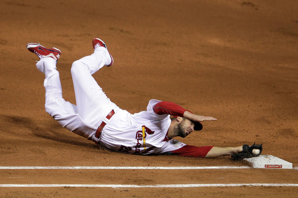 ST LOUIS, MO - OCTOBER 19: Chris Carpenter #29 of the St. Louis Cardinals tags first base for an out in the first inning during Game One of the MLB World Series against the Texas Rangers at Busch Stadium on October 19, 2011 in St Louis, Missouri. (Photo by Doug Pensinger/Getty Images)