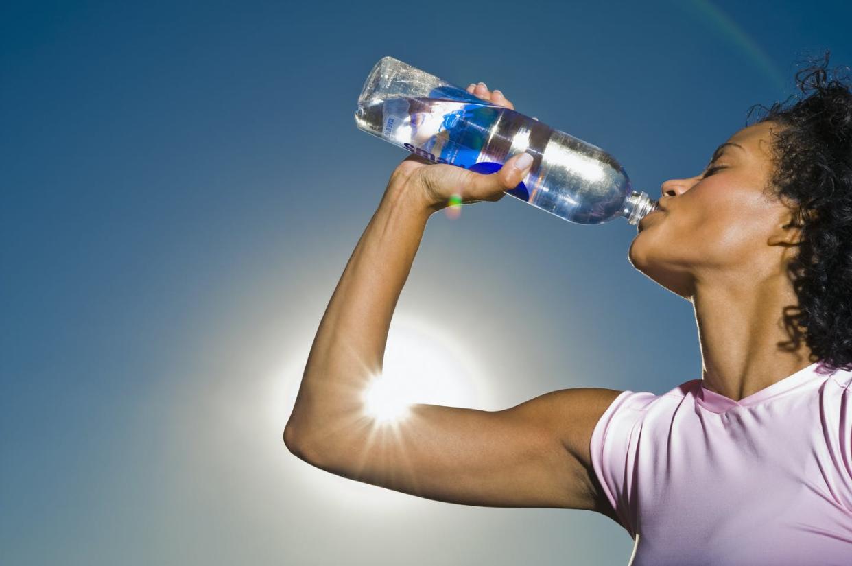 <span class="caption">The chemical BPA has been shown to leach from food packaging products into our bodies.</span> <span class="attribution"><a class="link " href="https://www.gettyimages.com/detail/photo/african-woman-drinking-water-royalty-free-image/90306673?adppopup=true" rel="nofollow noopener" target="_blank" data-ylk="slk:Jacobs Stock Photography Ltd/DigitalVision via Getty Images;elm:context_link;itc:0;sec:content-canvas">Jacobs Stock Photography Ltd/DigitalVision via Getty Images</a></span>