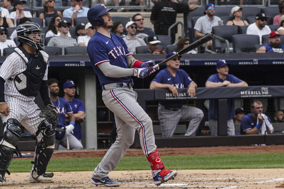 Texas Rangers' Jonah Heim watches his solo homer in the second inning of a baseball game against the New York Yankees, Sunday, June 25, 2023, in New York. (AP Photo/Bebeto Matthews)