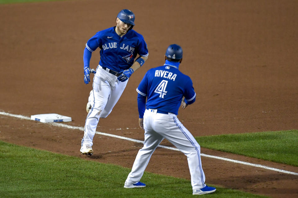 Toronto Blue Jays' Danny Jansen, left, is congratulated by third base coach Luis Rivera (4) after hitting a solo home run against the New York Yankees during the fourth inning of a baseball game in Buffalo, N.Y., Wednesday, Sept. 23, 2020. (AP Photo/Adrian Kraus)