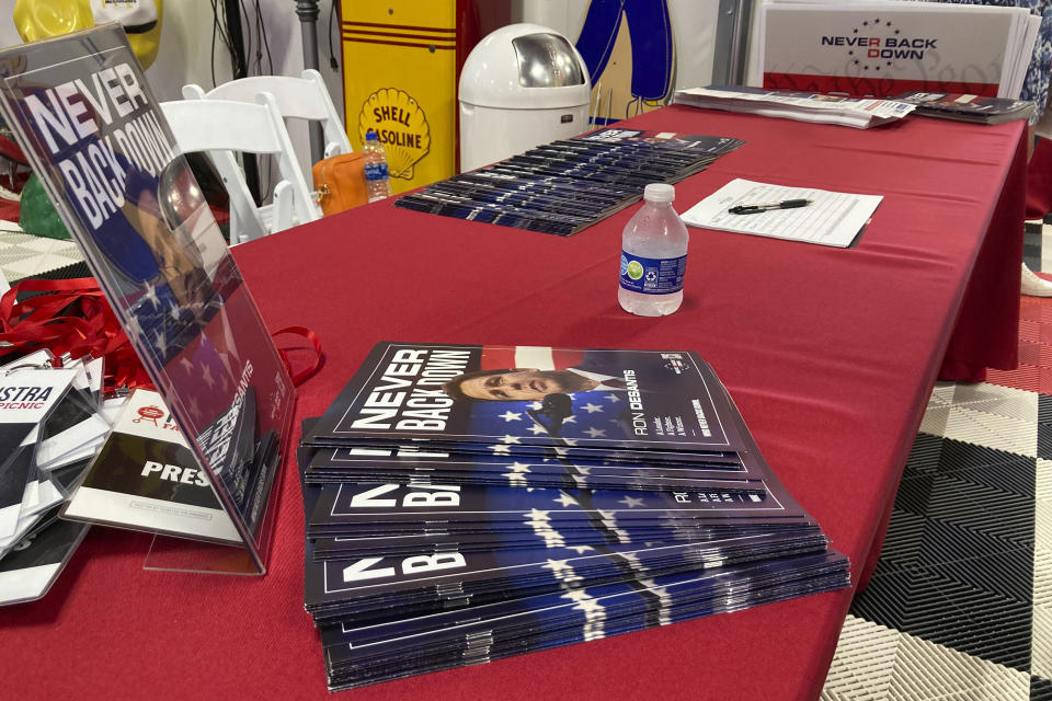 The super PAC promoting Florida Gov. Ron DeSantis displays information sign-up sheets and pledge cards for Iowans attending a Republican Iowa congressional fundraiser DeSantis headlined on May 13, 2023, in Sioux Center, Iowa. The super PAC, Never Back Down, is taking on the labor-intensive task of organizing support in the 2024 Iowa caucuses for DeSantis, though barred by law from coordinating with the candidate. (AP Photo/Tom Beaumont)