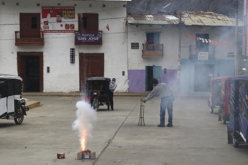 Supporters of President-elect Pedro Castillo launch fireworks during a live broadcast of his swearing-in ceremony at a public square in Tacabamba, Peru, located in the Cajamarca department where Castillo is from, Wednesday, July 28, 2021, on his Inauguration Day. (AP Photo/Francisco Vigo)