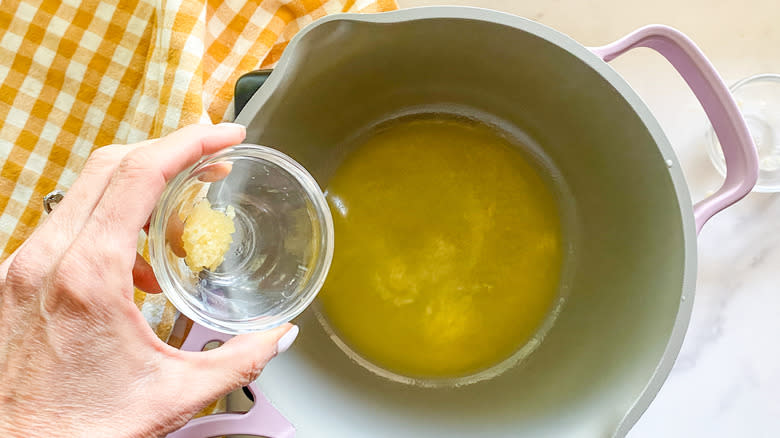 Adding garlic to pot