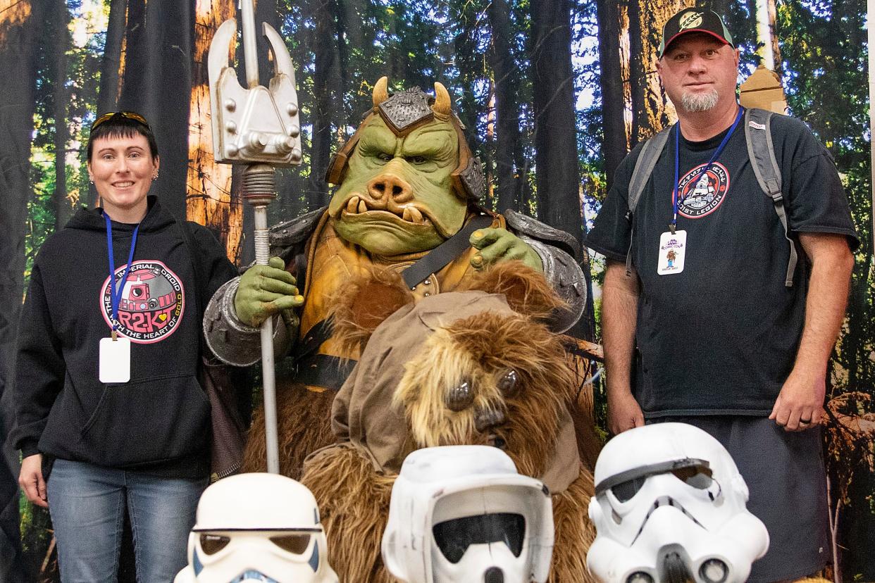 Star war nerds Heather and James Womack, from Lodi take a photo with a Gemmorian Guard (Cas Castillo) at the Lodi Comic Con at Lodi Grape Festival on May 8. Dianne Rose/For The Record