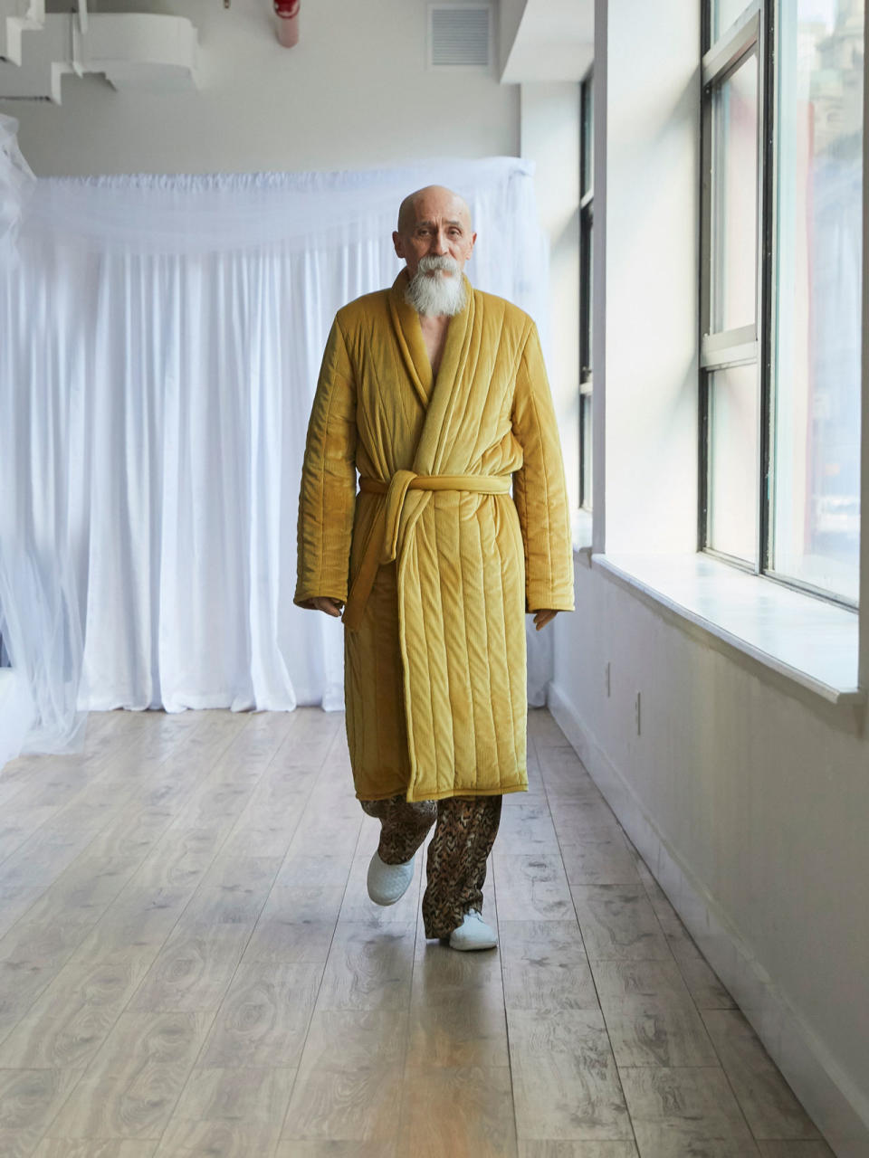 <p>Older male model wears a yellow robe and leopard trousers at the Collina Strada Fall/Winter 2018 show. (Photo: Jonathan Hokklo) </p>