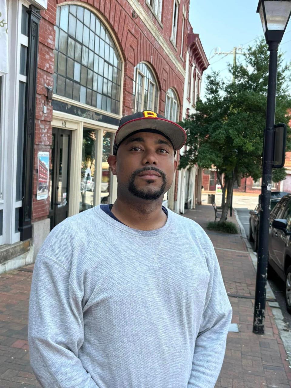 During a heat wave, Taivon Jones of Petersburg bundles up wearing two long-sleeved shirts in Old Towne on July 16, 2024 to be prepared for any type of weather change.