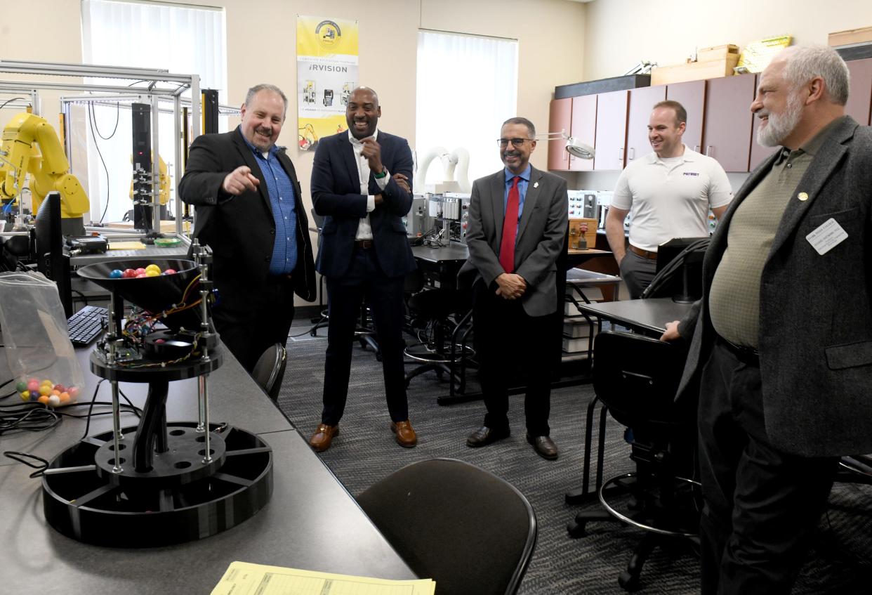 Donald Ball, dean of business, engineering and information technologies at Stark State College, far left, leads a tour for Intel representatives on campus Friday for the school's new Intel/Dell AI lab in the W.R. Timken Center for Information Technology.