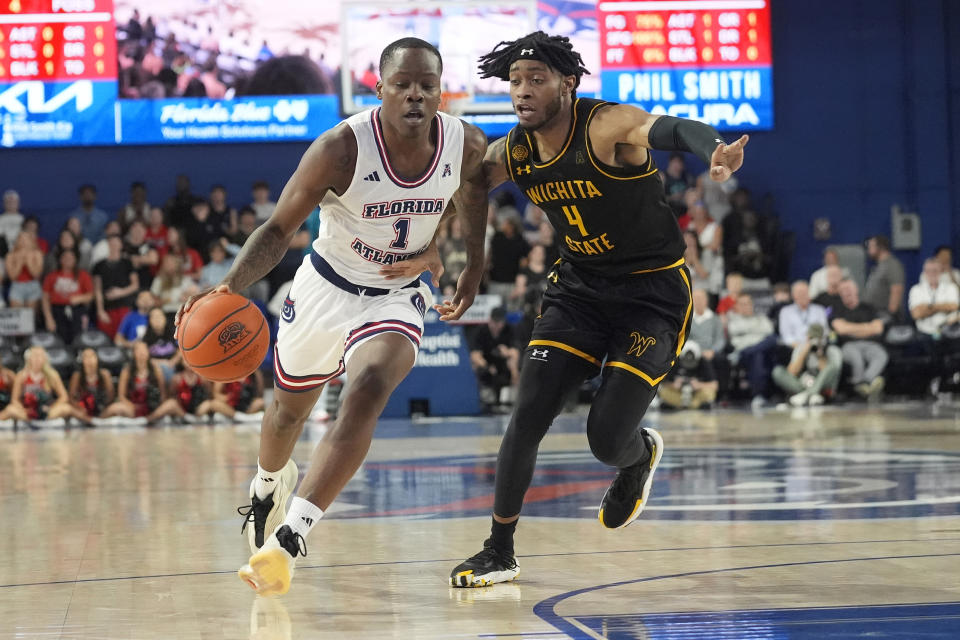 Florida Atlantic guard Johnell Davis (1) dribbles the ball as Wichita State guard Colby Rogers (4) defends during the first half of an NCAA college basketball game, Thursday, Jan. 18, 2024, in Boca Raton, Fla. (AP Photo/Marta Lavandier)