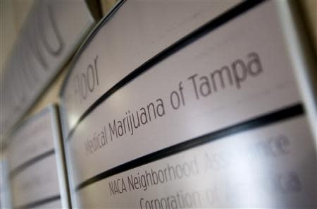 An office building sign directs visitors to Florida's first marijuana business school, Medical Marijuana Tampa, in Tampa, Florida May 6, 2014. REUTERS/Scott Audette