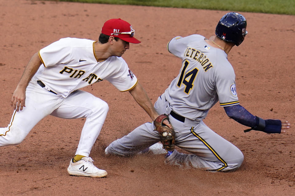 Milwaukee Brewers' Jace Peterson, right, steals second as Pittsburgh Pirates second baseman Adam Frazier applies a late tag after taking a throw from catcher Jacob Stallings during the sixth inning of a baseball game in Pittsburgh, Saturday, July 3, 2021. (AP Photo/Gene J. Puskar)