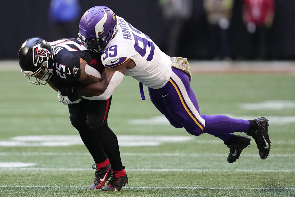 Minnesota Vikings linebacker Danielle Hunter (99) tackles Atlanta Falcons running back Tyler Allgeier, left, during the first half of an NFL football game, Sunday, Nov. 5, 2023, in Atlanta. (AP Photo/Mike Stewart)