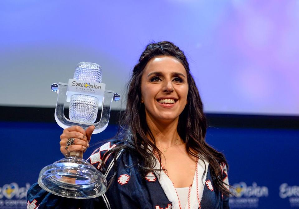 Ukrainian Crimean Tatar singer Jamala shows off her trophy at a press conference after winning the Eurovision Song Contest final at the Ericsson Globe Arena in Stockholm, on May 15, 2016. (MAJA SUSLIN/TT/AFP via Getty Images)