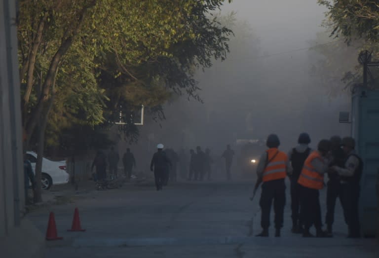 Afghan security personnel investigate the site of the suicide bombing