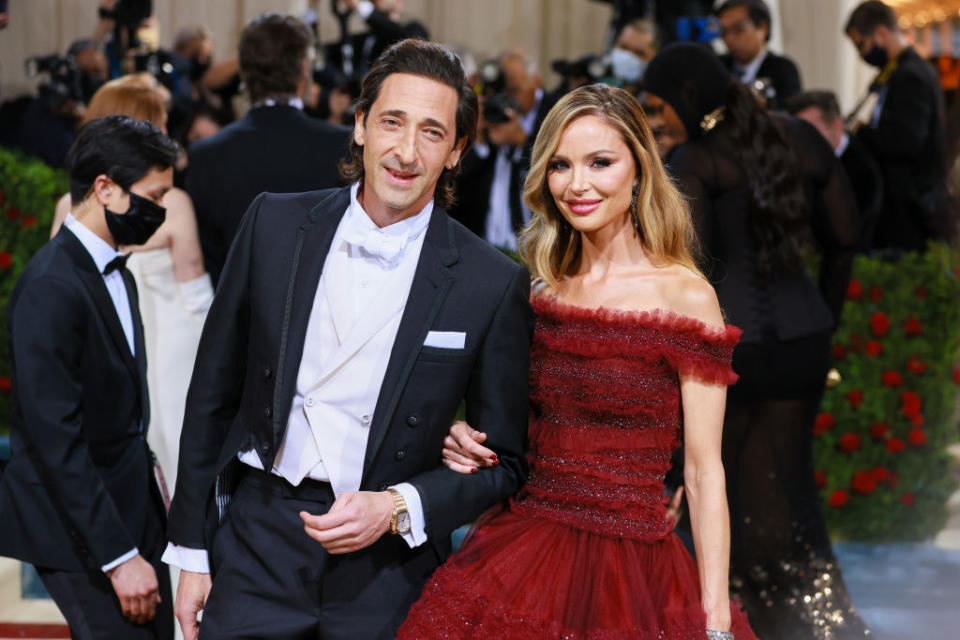 Adrien Brody and Georgina Chapman smile on the red carpet