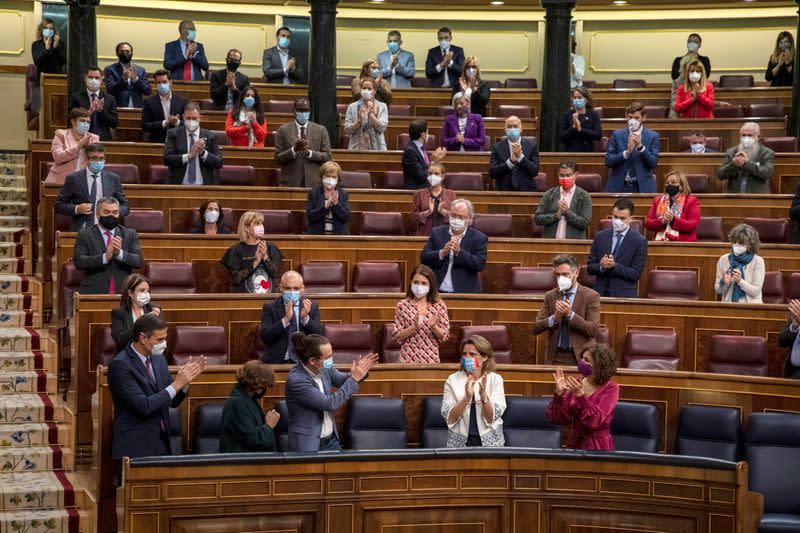 Spanish Prime Minister Pedro Sanchez and deputies applaud during a no confidence motion at Parliament in Madrid