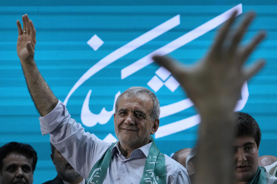 Iranian presidential candidate Masoud Pezeshkian waves to his supporters while campaigning in Tehran, Iran, Sunday, June 23, 2024. (AP Photo/Vahid Salemi)