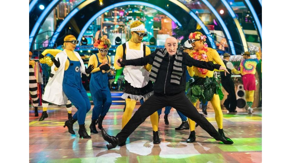 Kai Widdrington as Gru dancing with Kai Widdrington and Carlos Gu as Minions