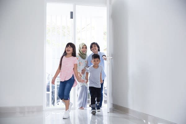 family with two kids entering their new house