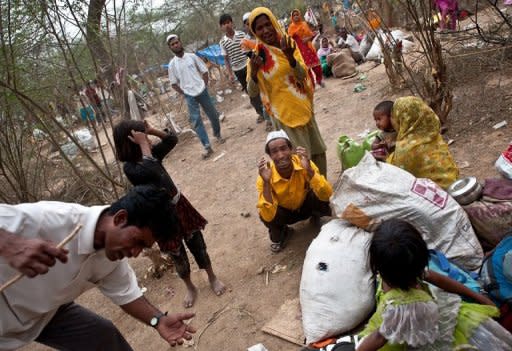 Myanmar refugees from the Rohingya community, a Muslim ethnic group, are seen at a makeshift camp in New Delhi on May 14, 2012. Over 2,000 refugees from Myanmar have set up a temporary camp in south Delhi near a protected monument. The UNHCR has issued them asylum seeker cards but they have been demanding refugee status