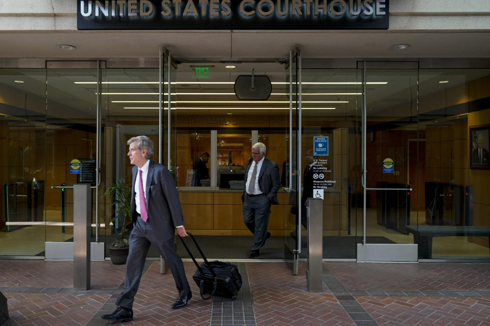 Robert Walters, front, attorney representing three LIV Golf players, leaves a federal courthouse in San Jose, Calif., Tuesday, Aug. 9, 2022. A federal judge has ruled that three golfers who joined Saudi-backed LIV Golf will not be able to compete in the PGA Tour's postseason. (AP Photo/Godofredo A. Vásquez)