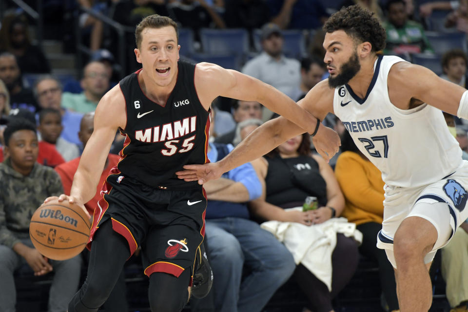 Miami Heat guard Duncan Robinson (55) handles the ball against Memphis Grizzlies forward David Roddy (27) in the first half of a preseason NBA basketball game Friday, Oct. 7, 2022, in Memphis, Tenn. (AP Photo/Brandon Dill)