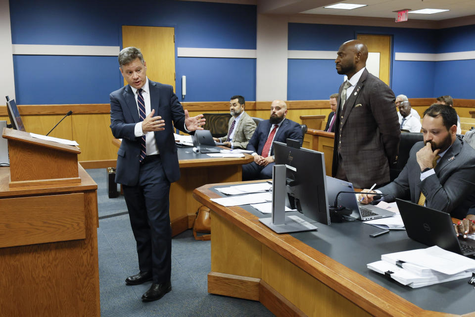 Attorney Brian Rafferty, left, representing Sidney Powell, speaks before Fulton County Superior Court Judge Scott McAfee, not pictured, in Atlanta on Thursday, Sept. 14, 2023. Donald Trump will not face trial next month in Georgia after McAfee ruled Thursday that the former president and 16 others accused of illegally trying to overturn the results of the 2020 election will be tried separately from two lawyers in the case. Lawyers Sidney Powell and Kenneth Chesebro had filed demands for a speedy trial, and McAfee set their trial to begin Oct. 23. (Miguel Martinez/Atlanta Journal-Constitution via AP, Pool)