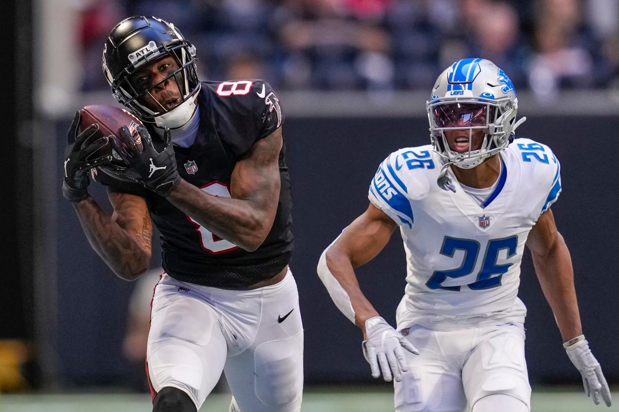 Falcons tight end Kyle Pitts catches a pass behind Lions cornerback Ifeatu Melifonwu during the second half of the Lions' 20-16 loss on Sunday, Dec. 26, 2021, in Atlanta.