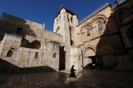 An Ethiopian monk walks at the Church of the Holy Sepulchre in Jerusalem's Old City December 27, 2013. REUTERS/Baz Ratner/Files