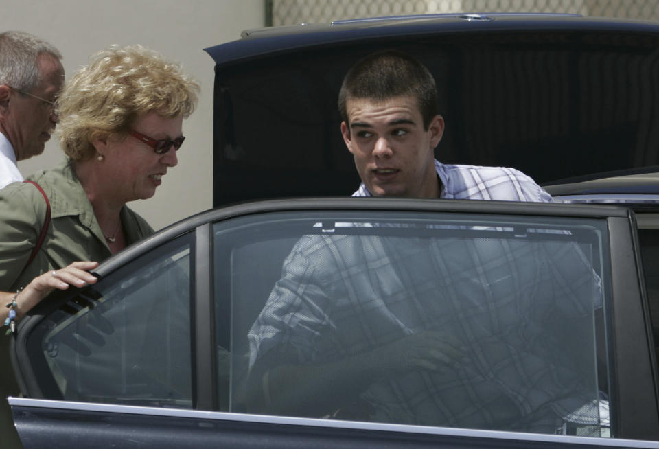 FILE - Dutch teen Joran van der Sloot, 18, enters his family's car as his mother Anita closes the door after he was conditionally released from the KAI jail in San Nicolas, Aruba, Sept. 3, 2005. Van der Sloot, the prime suspect in the 2005 disappearance of American student Natalee Holloway on a Dutch Caribbean island, is facing extradition from Peru in 2023 to face criminal charges in the United States, while he has never been charged in connection with her disappearance. (AP Photo/Leslie Mazoch, File)