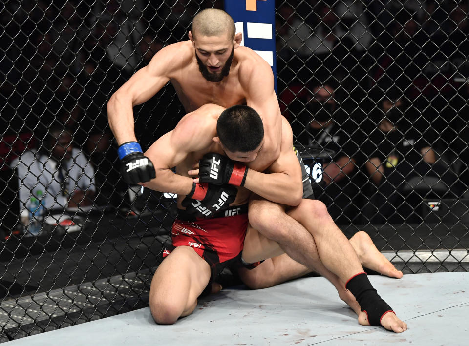 ABU DHABI, UNITED ARAB EMIRATES - OCTOBER 30: Khamzat Chimaev of Sweden punches Li Jingliang of China in a welterweight fight during the UFC 267 event at Etihad Arena on October 30, 2021 in Yas Island, Abu Dhabi, United Arab Emirates. (Photo by Chris Unger/Zuffa LLC)