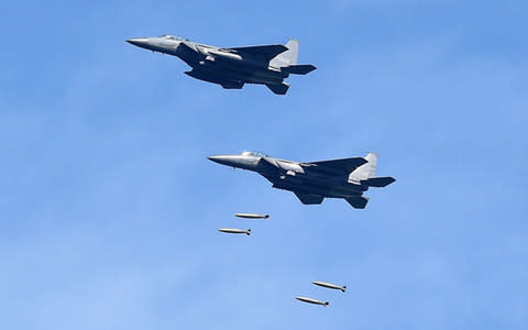 South Korea's F-15K fighter jets drop bombs during a training at the Taebaek Pilsung Firing Range  - Credit: Getty