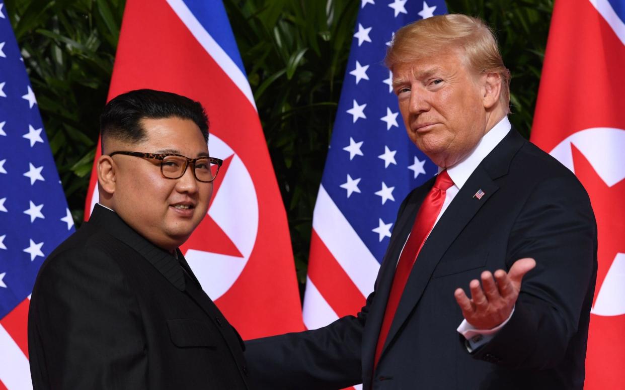 US President Donald Trump meets with North Korea's leader Kim Jong Un in their first summit on 12 June 2018 - AFP