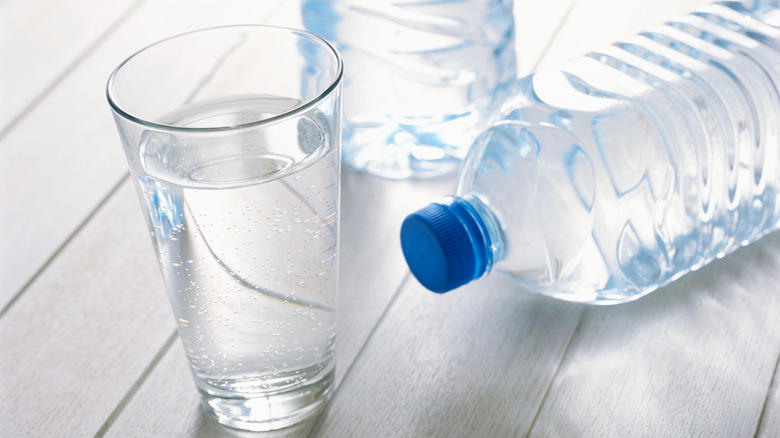 glass of water with water bottles