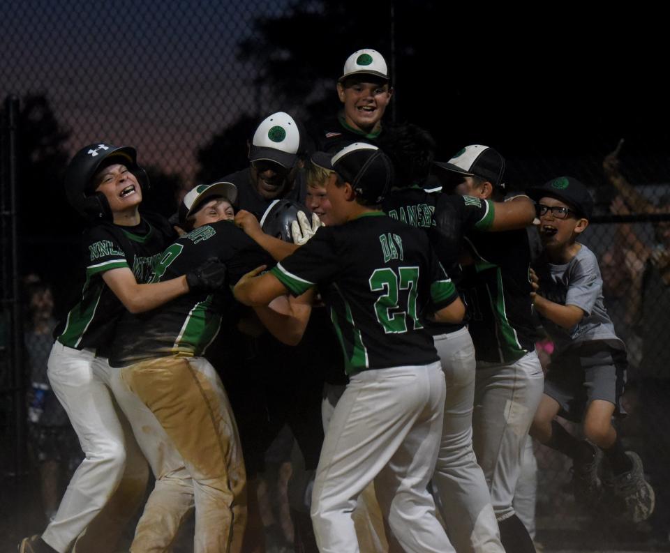 Mattingly Landscape celebrates after pulling out a 6-5 win in the bottom of the sixth inning against North Newark Little League rival Edward Jones, winning the Varsity Division championship in the 77th Licking County Shrine Tournament at Mound City.